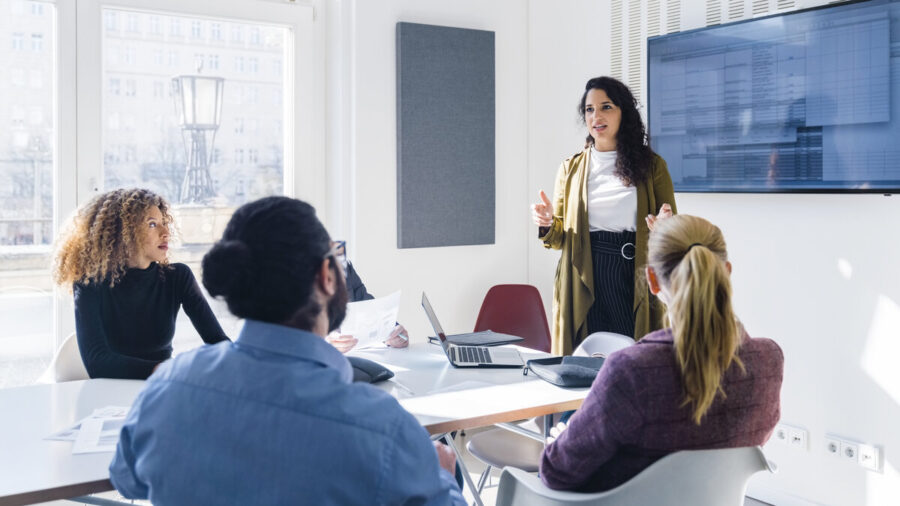 A manager addressing a room full of employees
